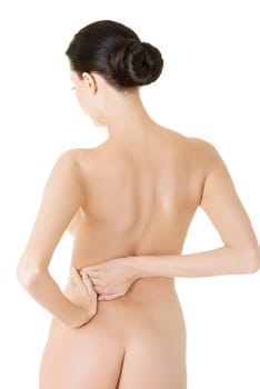 Young woman with pain in her back. Isolated on white background.
