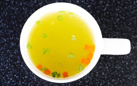 Broth in cup on table
