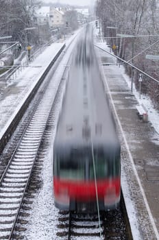 Motion blur red train at high speed on platform