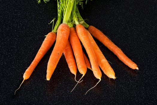Fresh carrots bunch on table