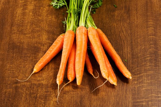 Fresh carrots bunch on table