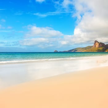 Beach and sea. Island on the background