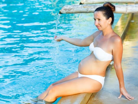 Beautiful pregnant woman in swimming pool