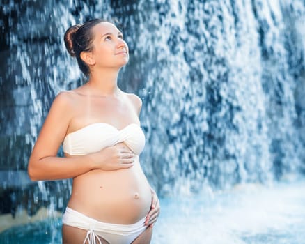 Beautiful pregnant woman in swimming pool