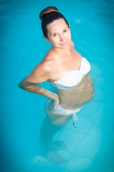 Beautiful pregnant woman in swimming pool