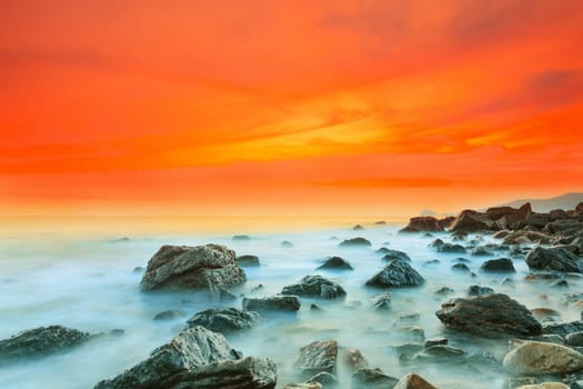 Sunrise over the sea. Stone on the foreground
