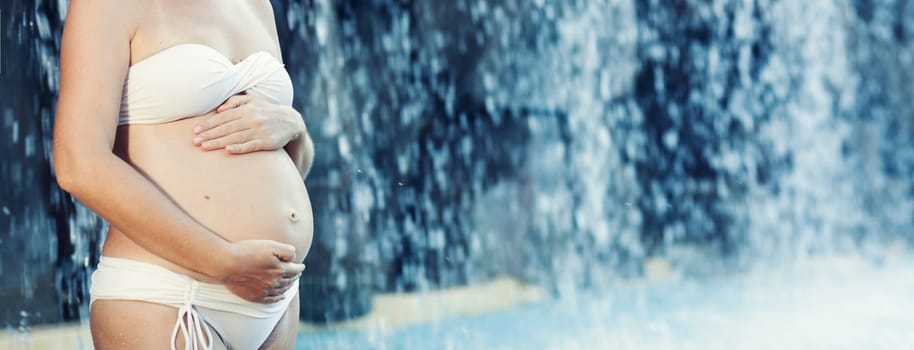 Beautiful pregnant woman in swimming pool