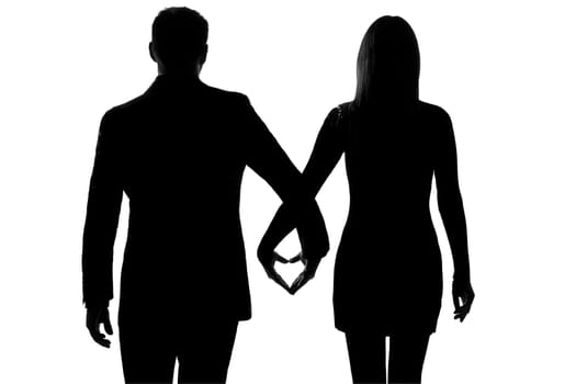 one lovers caucasian couple man and woman walking hand in hand in studio silhouette isolated on white background