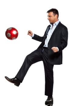 one caucasian business man playing juggling soccer ball in studio isolated on white background