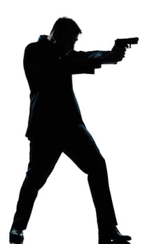 one caucasian spy criminal policeman detective man aiming shooting gun  full length silhouette in studio isolated white background