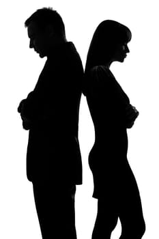 one caucasian couple standing back to back man and woman sad in studio silhouette isolated on white background