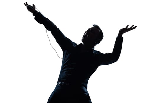 one caucasian man happy listening to music portrait silhouette in studio isolated white background