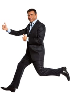 one caucasian business man running jumping double thumbs up in studio isolated on white background