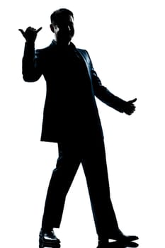 one caucasian man happy saluting shaka sign full length silhouette in studio isolated white background