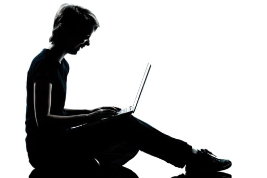 one caucasian young teenager silhouette boy girl computer computing laptop laughing full length in studio cut out isolated on white background