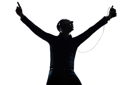 one caucasian man happy listening to music portrait silhouette in studio isolated white background
