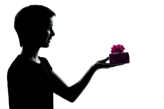 one caucasian young teenager silhouette boy or girl offering present gift  portrait in studio cut out isolated on white background