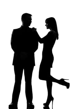 one caucasian couple man and woman standing face to face smiling in studio silhouette isolated on white background