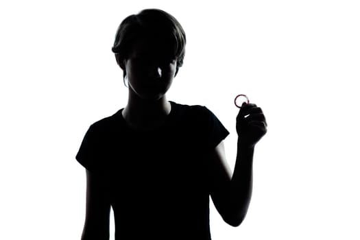 one caucasian young teenager silhouette boy or girl holding condom  portrait in studio cut out isolated on white background