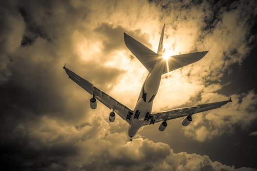 abstract of a large passenger jet landing through golden clouds