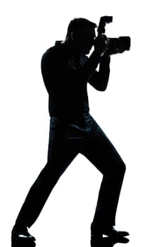 one caucasian man photographer full length silhouette in studio isolated white background