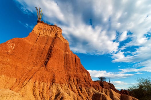 Towering formation of red stone with deep blue sky in a desert