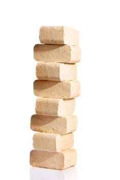 Wood sawdust briquettes , isolated on white