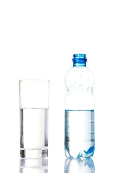 Bottle of water and glass. Isolated on white.