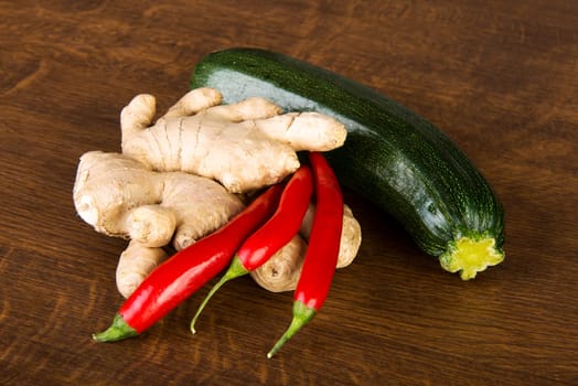 Zucchini, imbir and red hot chilie peppers on kitchen table