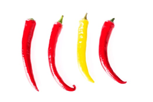 Red and yellow hot chilie peppers, isolated on white