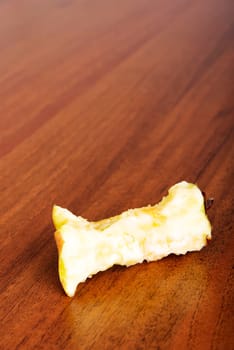 Bitten apple on the table or floor