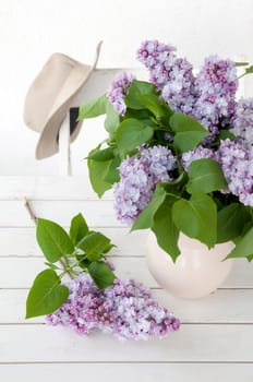 Lilac in vase on wooden surface