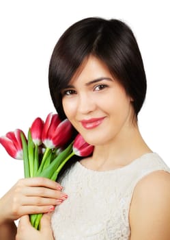 Beautiful young woman smelling a bunch of fresh red tulips