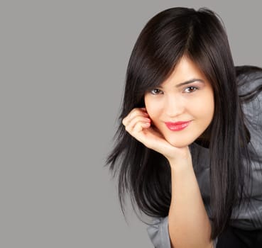 Portrait of a pretty young woman on a gray background