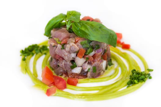 Freshly prepared tuna tartare served with wasabi on a white plate