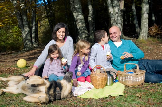 Happy family having picnic in autumn