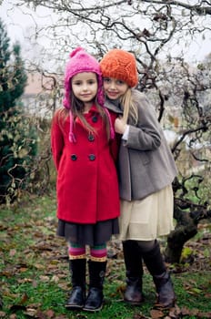 Two cute girls in vintage clothes posing