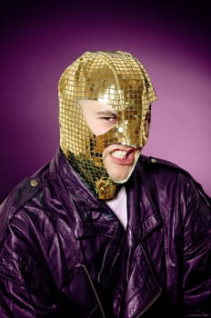 Man wearing gold mask and leather jacket