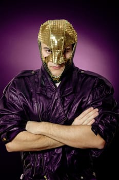 Man wearing gold mask and leather jacket