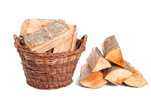 Firewood logs in wooden basket isolated on white