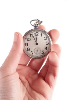 Pocket clock in hand. Isolated on white.