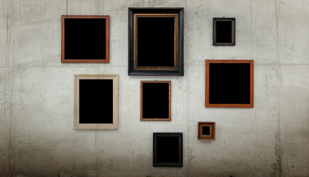 Wooden frames on concrete wall background