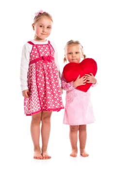 studio shot of two sisters with heart