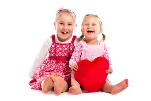 studio shot of two sisters with heart