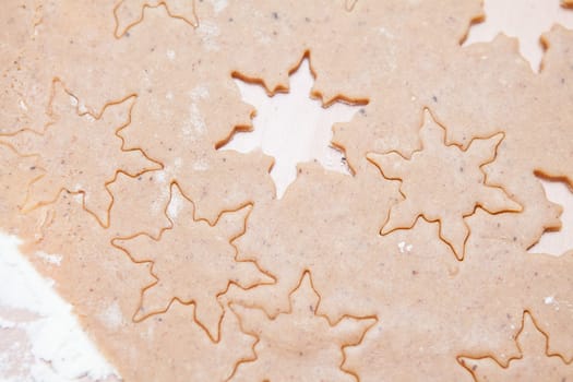 Closeup of gingerbread biscuit dough with star shapes