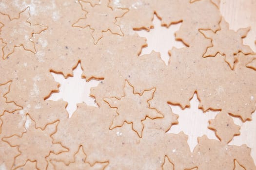 Closeup of gingerbread biscuit dough with star shapes