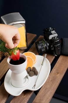 Dipping strawberry to hot fondue