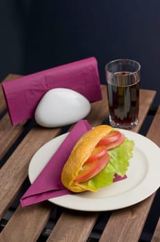 Fresh sandwich on plate and juice of glass