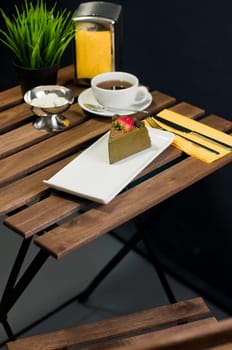 Coffee, cake, table set fork knife and flower