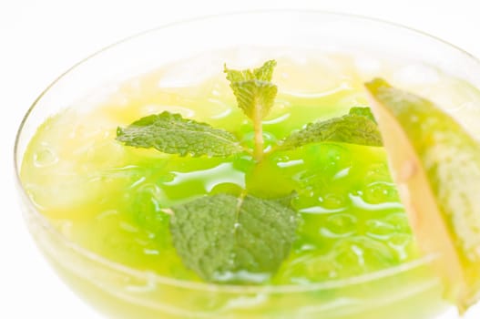 Citrus Paradise Cocktail made from Midori Melon, White Rum, pineapple, lime juice and garnishes with lime slice and fresh mints leaves